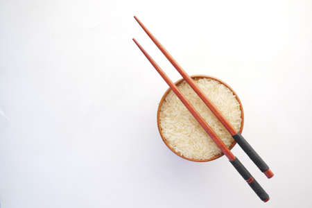 long grain brown rice in a bowl on white backgroundの写真素材