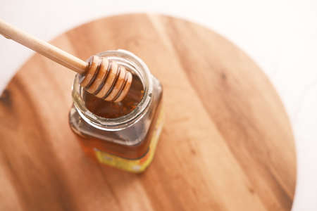 fresh honey with spoon on tableの写真素材