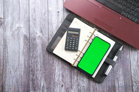 top view of smart phone, laptop and notepad on tableの写真素材