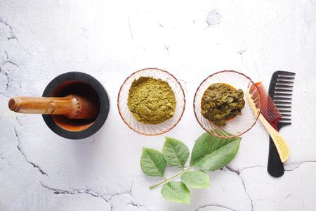 The wooden bowl with rehydrated henna on tableの写真素材
