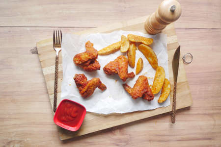 grill chicken and sweet potato wedges on a boardの写真素材