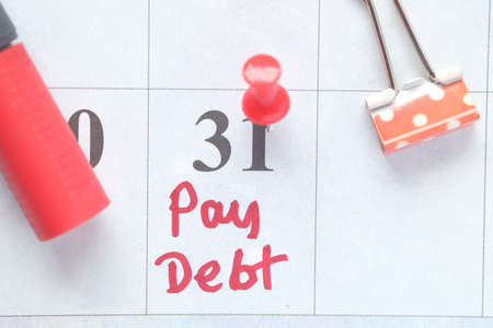 Close up of pay debt word on calendarの写真素材