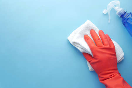 person hand cleaning on blue backgroundの写真素材