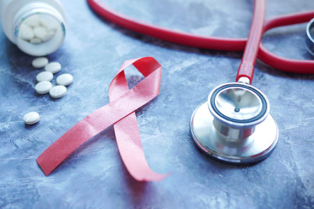 Red ribbon HIV, and stethoscope on black background.の写真素材