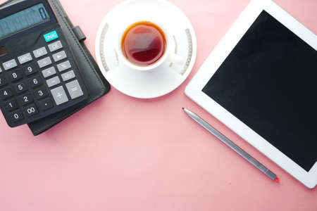 Flat composition of digital tablet and office stationary on pink backgroundの写真素材