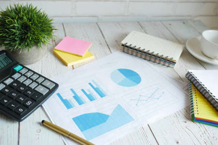 financial graph, calculator and notepad on tableの写真素材