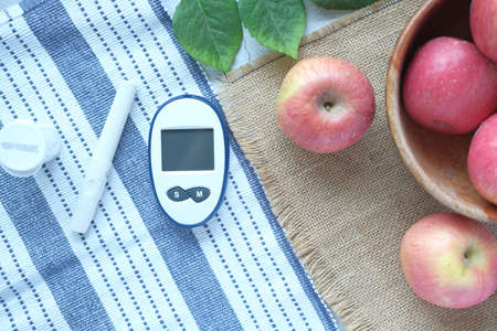 diabetic measurement tools and fresh apple on tableの写真素材