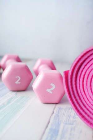 pink color dumbbell, exercise mat and water bottle on white backgroundの写真素材
