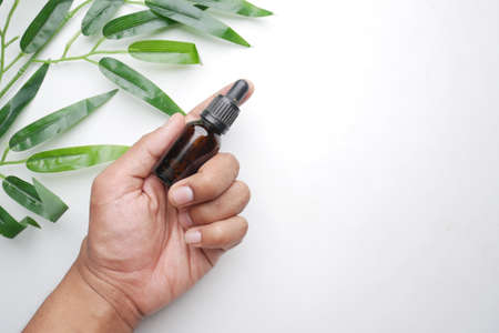 eucalyptus essential oils in a glass bottle with green leaf on white backgroundの写真素材