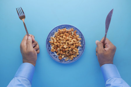cashew nut on a plate of blue backgroundの写真素材