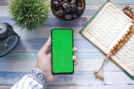 smart phone, Holy book Quran and rosary on table,の写真素材