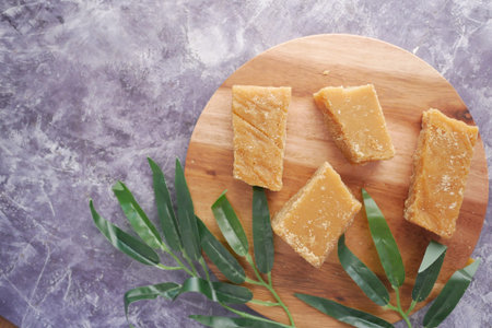 stack of Jaggery traditional cane sugar cube on tableの写真素材