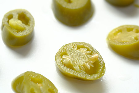 slice of Jalapeno peppers on white backgroundの写真素材