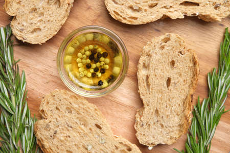 slice of whole meal bread and olive oil on tableの写真素材