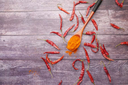 Chili powder and dried peppers on table background.の写真素材