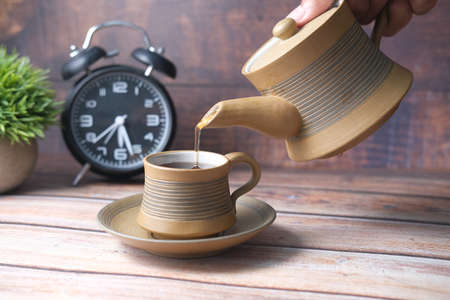 pouring tea from a tea ceremony top downの写真素材