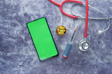 Insulin pens smart phone , pills and stethoscope on black backgroundの写真素材