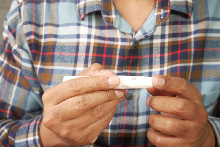 mans hand measuring blood sugar level