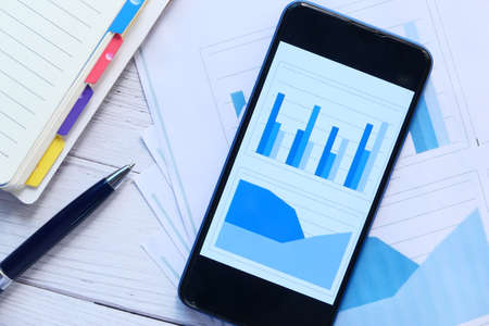 financial charts display on smart phone on tableの写真素材