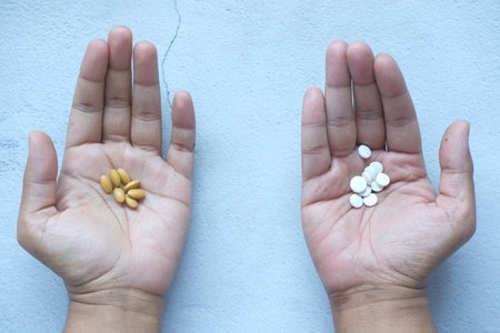herbal medicine and medical pills on palm of handの写真素材