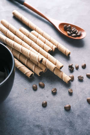 wafer roll chocolate , coffee beans and coffee mug on table ,の写真素材