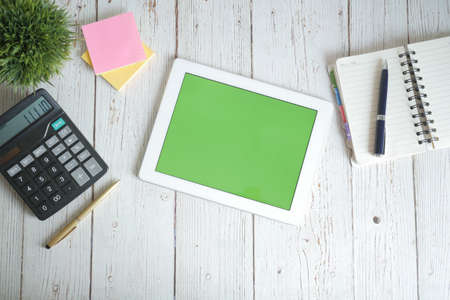 top view of digital tablet with office suppliers on tableの写真素材