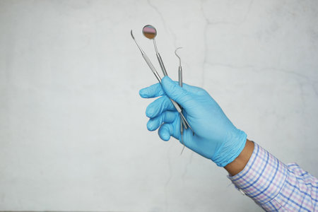 hand in latex gloves holding dental equipment ,の写真素材