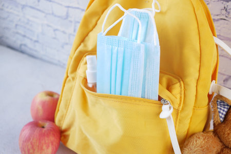 Student school bag pack with sanitizer, a face mask.