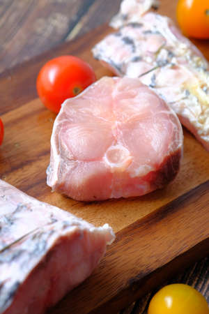 raw fresh fish on a chopping board for preparing for cooking on table ,の写真素材
