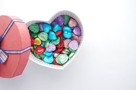 small heart shape gift with candy on white backgroundの写真素材