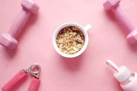 mixed nut in a bowl, milk and dumbbell on tableの写真素材