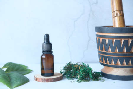 eucalyptus essential oils in a glass bottle with green leaf on white backgroundの写真素材