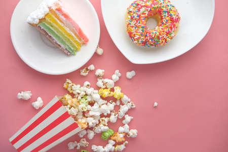 cake ,donuts and popcorn on pinkの写真素材