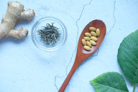 herbal medicine on spoon and herbs on table ,の写真素材