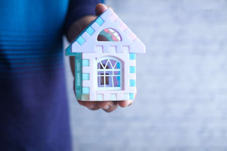 the concept of finance concept , man holding house in handの写真素材