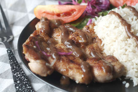 detail shot of grill chicken , rice and salad on plate on tableの写真素材