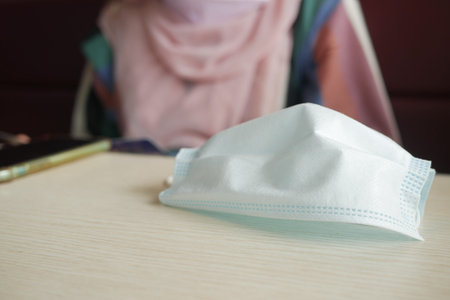 Close up of blue surgical masks on cafe table