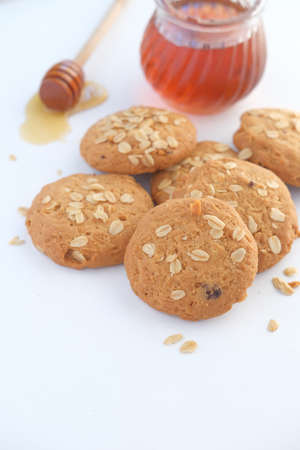 stack of whole meal cookies and honey on wooden backgroundの写真素材