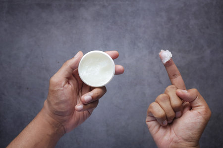 Close up of man hand using petroleum jelly