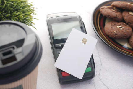 contactless payment concept with young man paying with credit cardの写真素材
