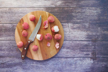 Lychee on a chopping board on tableの写真素材