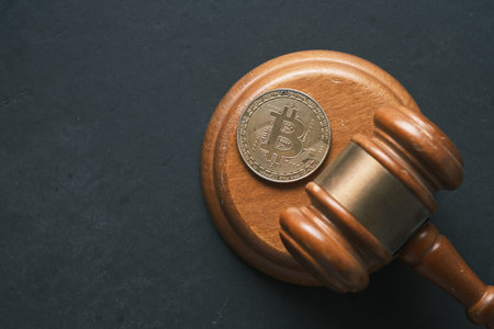 dhaka, bangladesh, 23th may 2021.golden bitcoins and gavel on table