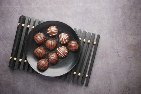 dark chocolate on a plate on black background