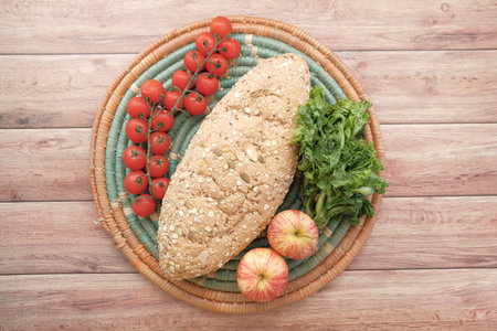 whole meal bread, apple and cherry tomato on table