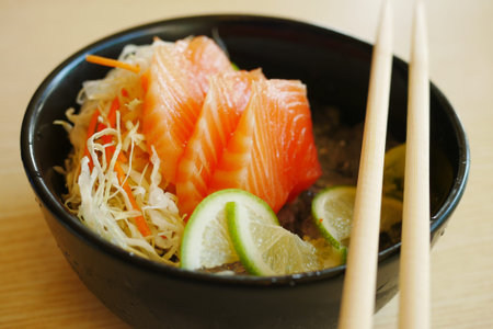 Portioned raw salmon fillets in ice with lemon.