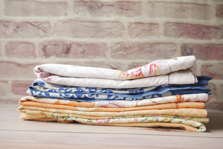 close up of stack of clothes on table .