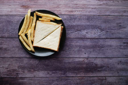 egg sandwich and chips on plate close upの写真素材