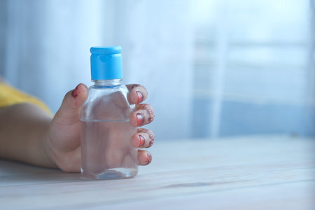 child hand using sanitizer gel for preventing virus with copy spaceの写真素材