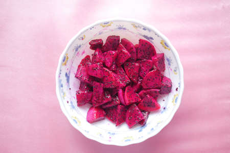 slice of dragon fruit on in a bowl on pink .の写真素材