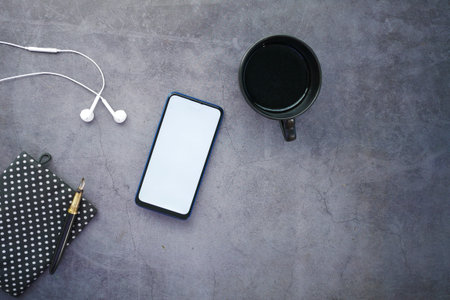 top view of smart phone and ear phone on table